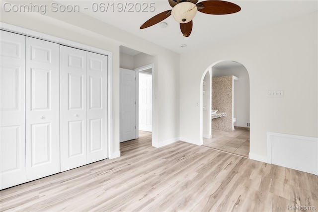 25044 Comfort, Center Line, MI 48015 - unfurnished bedroom with arched walkways, a closet, wood finished floors, and ceiling fan