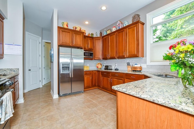 8734 Oakland Hills Cir Unit 6, Portage, MI 49024 - kitchen featuring appliances with stainless steel finishes, decorative backsplash, light stone counters, and recessed lighting