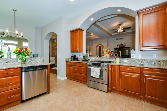 8734 Oakland Hills Cir Unit 6, Portage, MI 49024 - kitchen with stainless steel appliances, arched walkways, ceiling fan, brown cabinets, and light stone countertops