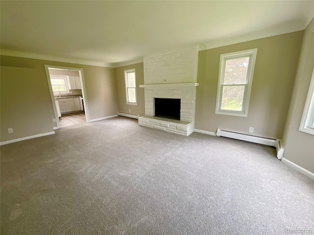 3615 N Mill Rd, Dryden, MI 48428 - unfurnished living room with a baseboard radiator, carpet, and a fireplace