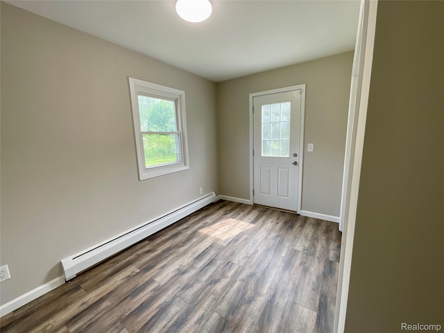 3615 N Mill Rd, Dryden, MI 48428 - spare room featuring baseboard heating and wood finished floors