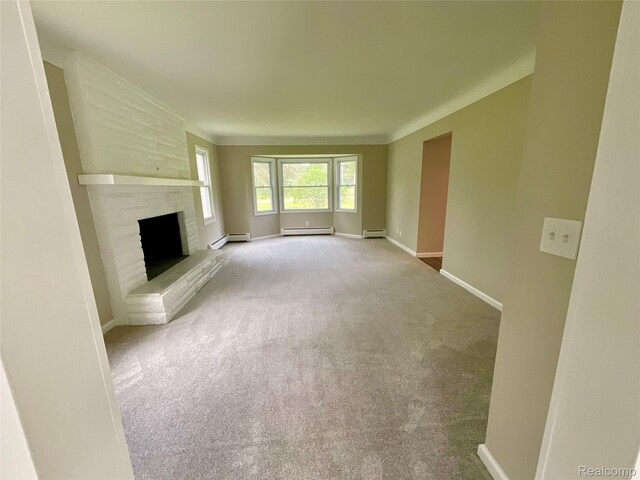 3615 N Mill Rd, Dryden, MI 48428 - unfurnished living room featuring a baseboard radiator, a fireplace, and carpet floors