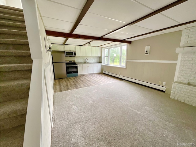3615 N Mill Rd, Dryden, MI 48428 - unfurnished living room with a baseboard heating unit, stairway, light carpet, and a wainscoted wall