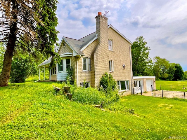 3615 N Mill Rd, Dryden, MI 48428 - view of side of home featuring a chimney, a garage, and brick siding