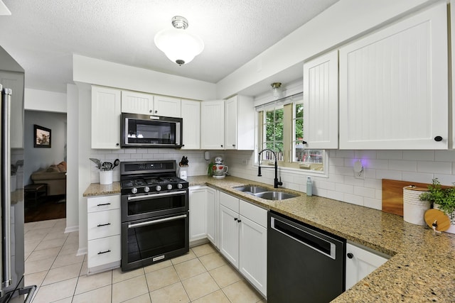 1548 Old Hickory Ln, Saint Joseph, MI 49085 - kitchen with dishwasher, double oven range, tasteful backsplash, white cabinetry, and a textured ceiling
