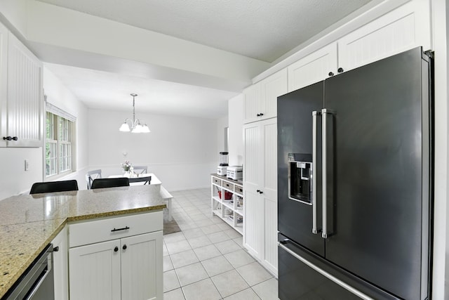 1548 Old Hickory Ln, Saint Joseph, MI 49085 - kitchen with high quality fridge, light tile patterned flooring, white cabinets, decorative light fixtures, and a chandelier
