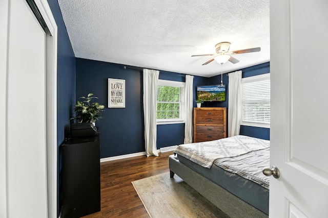 1548 Old Hickory Ln, Saint Joseph, MI 49085 - bedroom with dark wood-type flooring, a textured ceiling, and ceiling fan