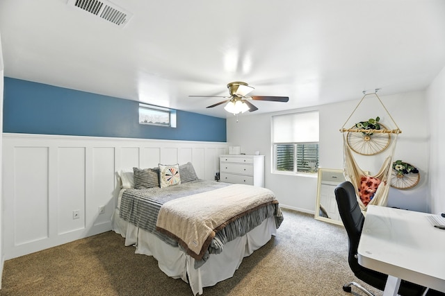 1548 Old Hickory Ln, Saint Joseph, MI 49085 - carpeted bedroom featuring multiple windows, wainscoting, and ceiling fan
