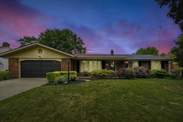 1548 Old Hickory Ln, Saint Joseph, MI 49085 - ranch-style home featuring a chimney, brick siding, an attached garage, and concrete driveway