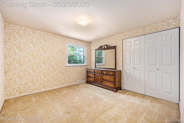1925 Dawn Ridge Rd, Commerce Twp, MI 48390 - unfurnished bedroom featuring carpet flooring, wallpapered walls, and a closet