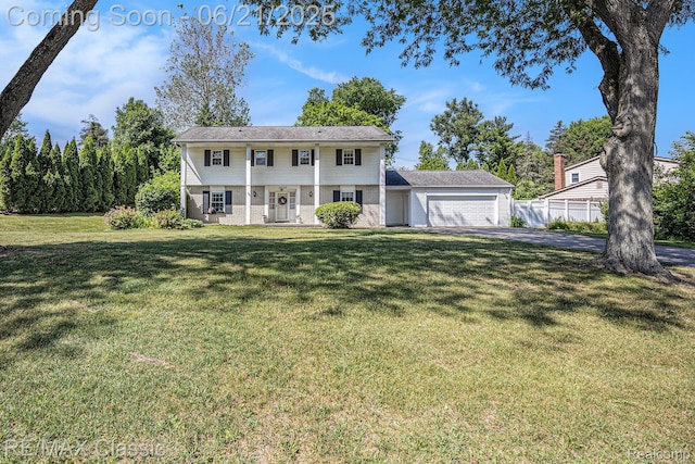1925 Dawn Ridge Rd, Commerce Twp, MI 48390 - colonial-style house with an attached garage, brick siding, and asphalt driveway