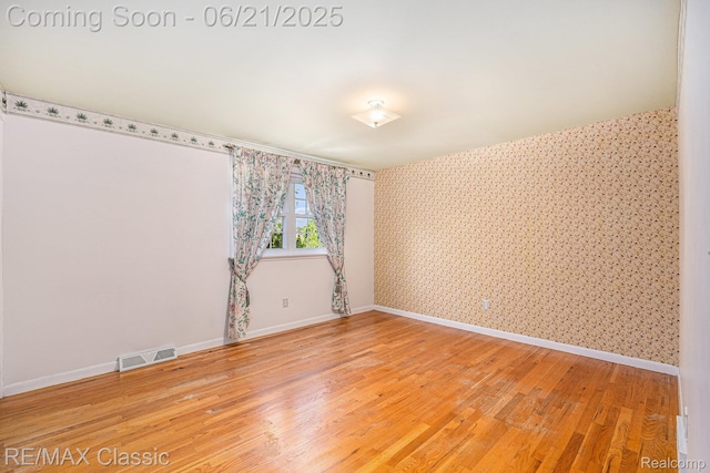 1925 Dawn Ridge Rd, Commerce Twp, MI 48390 - unfurnished room with wallpapered walls and light wood-style floors