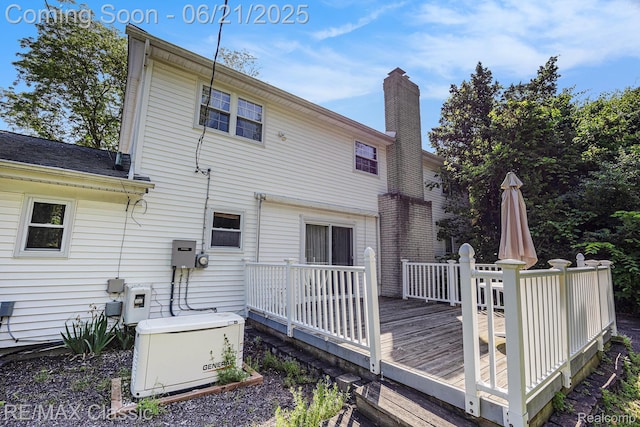1925 Dawn Ridge Rd, Commerce Twp, MI 48390 - back of house featuring a wooden deck and a chimney
