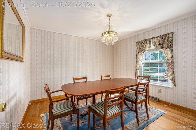 1925 Dawn Ridge Rd, Commerce Twp, MI 48390 - dining area featuring light wood-type flooring, a chandelier, and crown molding