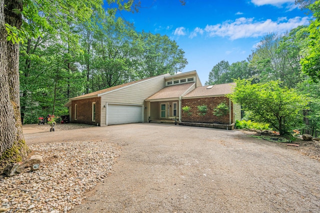 13421 Woodland Ct, Big Rapids, MI 49307 - mid-century inspired home featuring driveway, a garage, brick siding, and roof with shingles