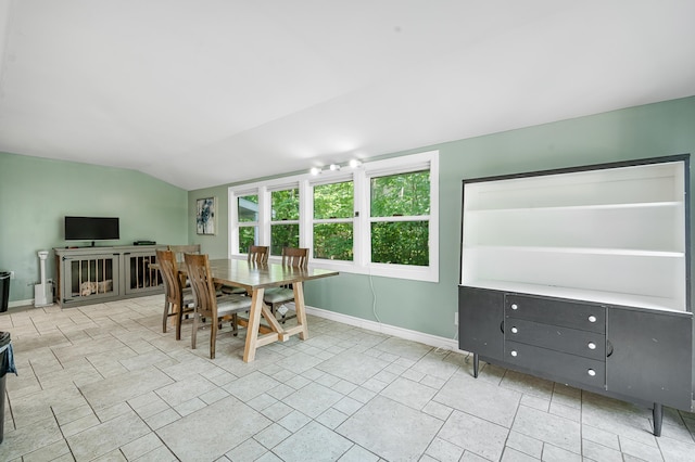 13421 Woodland Ct, Big Rapids, MI 49307 - dining room featuring lofted ceiling and baseboards