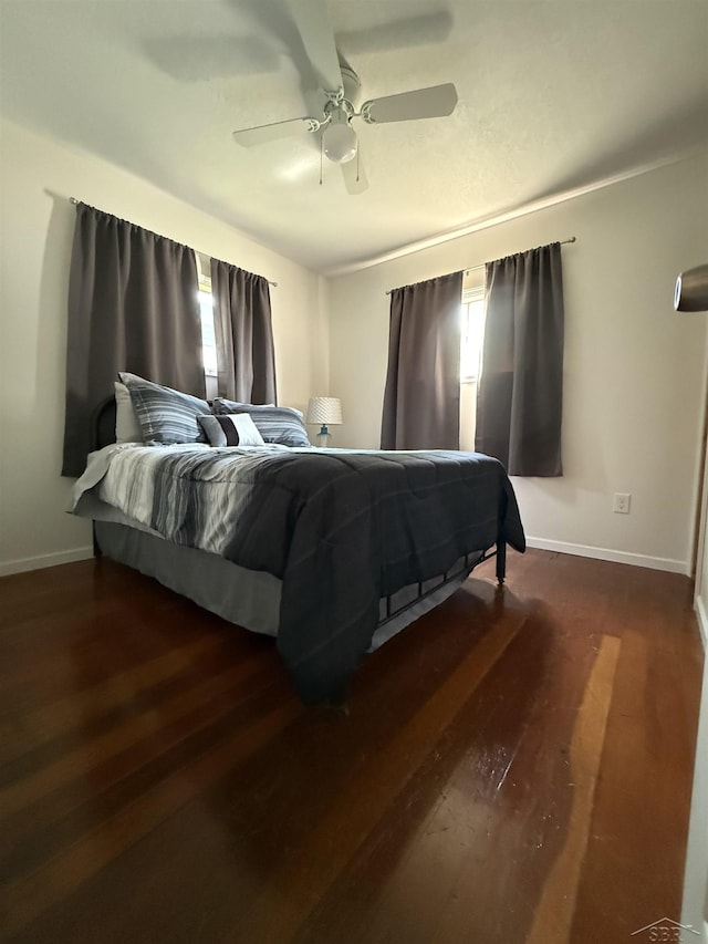 578 W Houghton Lake Dr, Prudenville, MI 48651 - bedroom with dark wood-style floors and ceiling fan