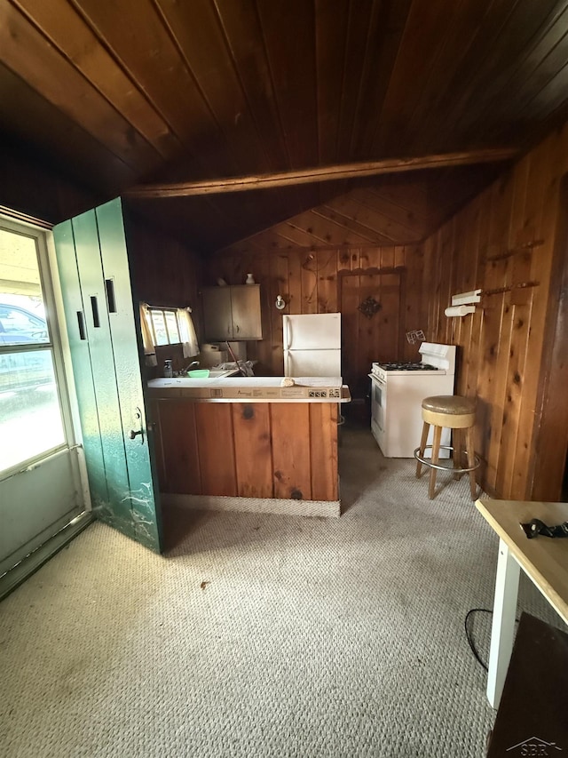 578 W Houghton Lake Dr, Prudenville, MI 48651 - kitchen featuring white appliances, a peninsula, wooden walls, healthy amount of natural light, and wooden ceiling