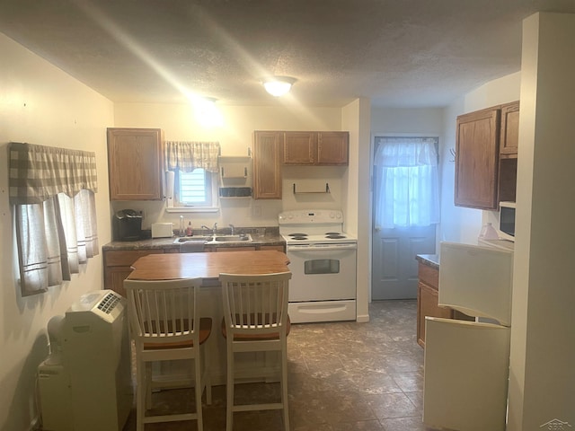 578 W Houghton Lake Dr, Prudenville, MI 48651 - kitchen with white range with electric cooktop, a textured ceiling, open shelves, brown cabinetry, and a kitchen breakfast bar