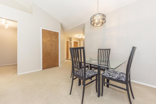 492 Colin Cir, Ann Arbor, MI 48103 - dining area with light carpet, vaulted ceiling, and a chandelier