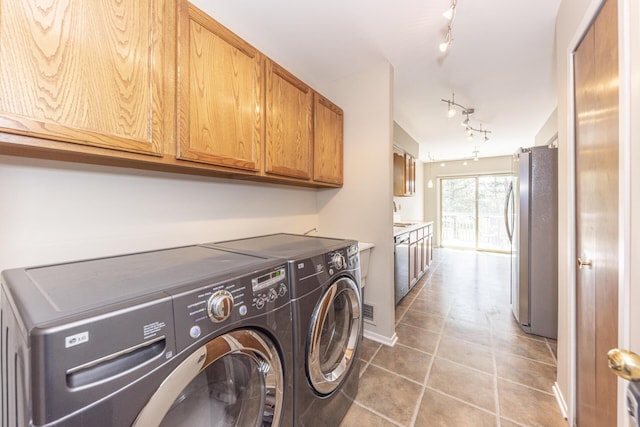 492 Colin Cir, Ann Arbor, MI 48103 - laundry room with independent washer and dryer, cabinet space, rail lighting, and light tile patterned floors