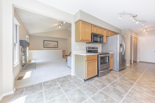 492 Colin Cir, Ann Arbor, MI 48103 - kitchen featuring track lighting, appliances with stainless steel finishes, open floor plan, light tile patterned floors, and lofted ceiling