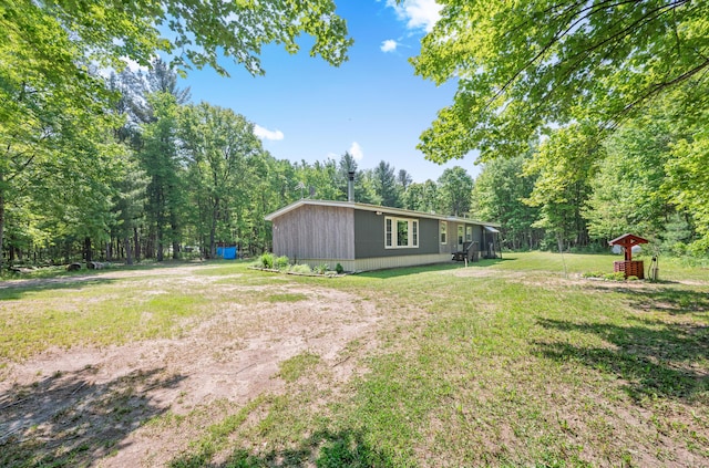 283 W 16th St, Baldwin, MI 49304 - view of green lawn with a wooded view