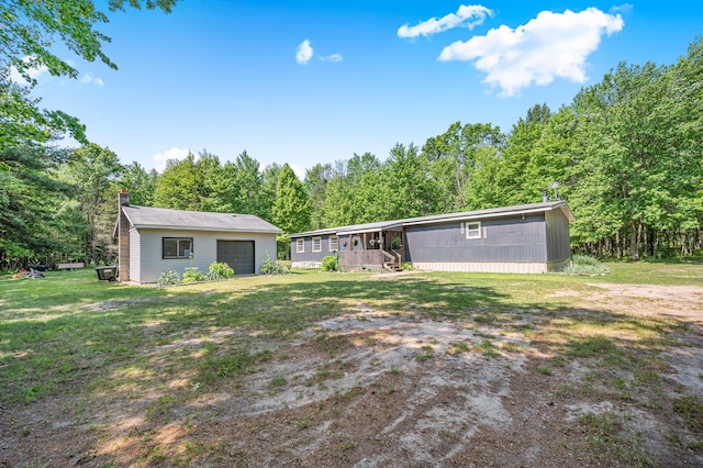 283 W 16th St, Baldwin, MI 49304 - rear view of property with an outbuilding, a chimney, a lawn, a garage, and a wooded view