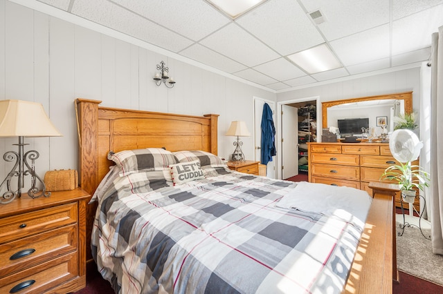 283 W 16th St, Baldwin, MI 49304 - bedroom with a spacious closet, a closet, dark colored carpet, and a drop ceiling