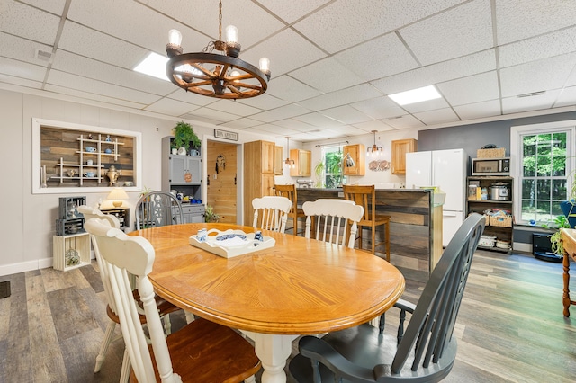 283 W 16th St, Baldwin, MI 49304 - dining room with light wood-style flooring, a chandelier, and a paneled ceiling