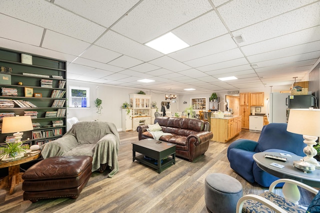 283 W 16th St, Baldwin, MI 49304 - living area with light wood-type flooring and a drop ceiling