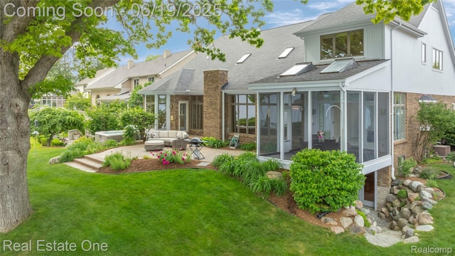 2505 Cedar Key Dr, Lake Orion, MI 48360 - rear view of property with a sunroom, brick siding, a patio, a shingled roof, and a yard