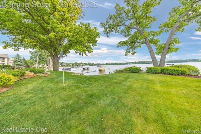 2505 Cedar Key Dr, Lake Orion, MI 48360 - view of grassy yard with a water view and a boat dock