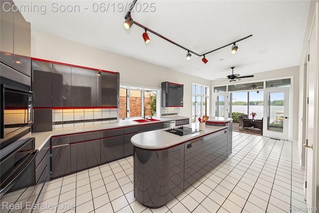 2505 Cedar Key Dr, Lake Orion, MI 48360 - kitchen featuring black appliances, a water view, light tile patterned floors, light countertops, and a ceiling fan