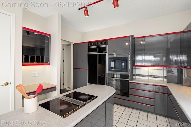 2505 Cedar Key Dr, Lake Orion, MI 48360 - kitchen featuring black appliances, light tile patterned floors, and light countertops