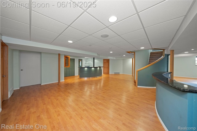 2505 Cedar Key Dr, Lake Orion, MI 48360 - unfurnished living room with light wood-style floors, stairway, a drop ceiling, and recessed lighting