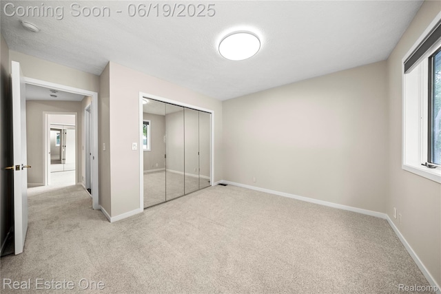 2505 Cedar Key Dr, Lake Orion, MI 48360 - unfurnished bedroom with carpet, multiple windows, and a closet