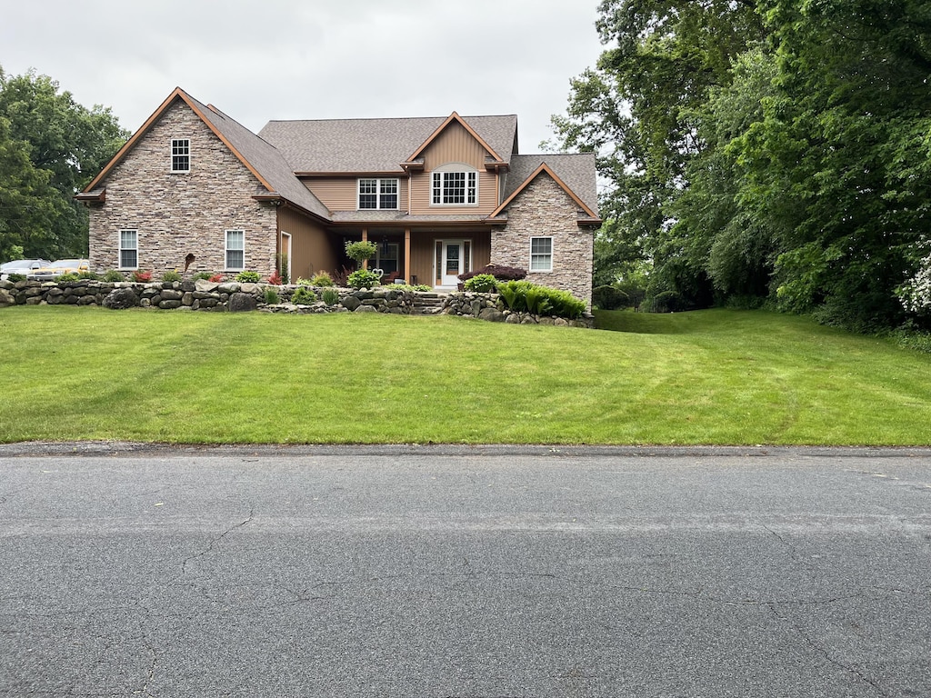 5374 Autumn Ct, Kalamazoo, MI 49009 - craftsman-style home with stone siding and a front lawn