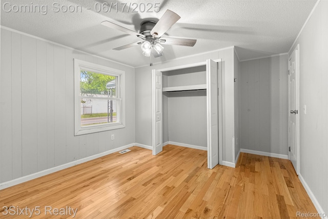 36513 Evans St, New Boston, MI 48164 - unfurnished bedroom with light wood finished floors, a textured ceiling, a closet, ceiling fan, and crown molding
