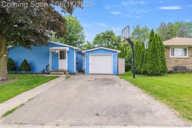 36513 Evans St, New Boston, MI 48164 - view of front of home featuring a front yard, a garage, asphalt driveway, and an outdoor structure