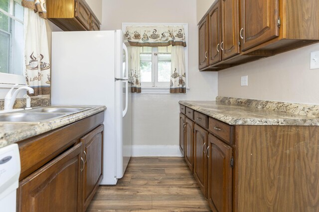 318 Cecil St, Buchanan, MI 49107 - kitchen featuring light countertops, dark wood-type flooring, freestanding refrigerator, and dishwashing machine