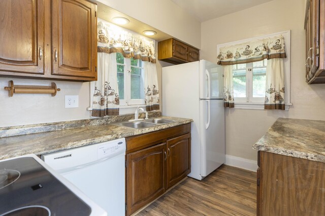 318 Cecil St, Buchanan, MI 49107 - kitchen with white appliances, healthy amount of natural light, dark wood-style floors, and brown cabinetry