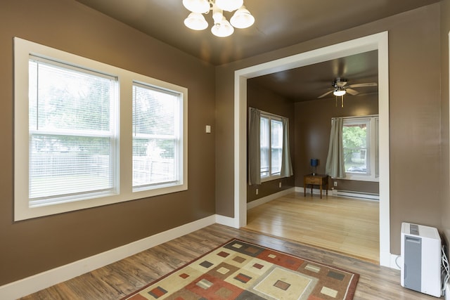 318 Cecil St, Buchanan, MI 49107 - entrance foyer with a chandelier, light wood finished floors, baseboard heating, and ceiling fan