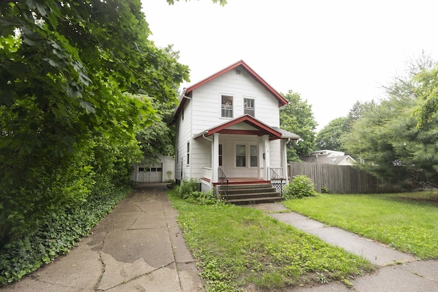 318 Cecil St, Buchanan, MI 49107 - view of front of home with a porch and a detached garage