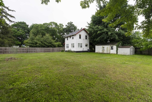 318 Cecil St, Buchanan, MI 49107 - fenced backyard with a shed and view of wooded area