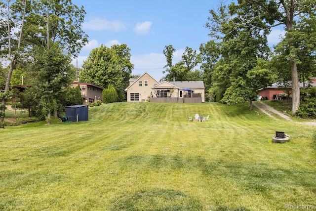 22085 Thorofare Rd, Grosse Ile, MI 48138 - view of green lawn with an outdoor fire pit