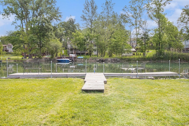 22085 Thorofare Rd, Grosse Ile, MI 48138 - view of green lawn featuring a boat dock and a water view