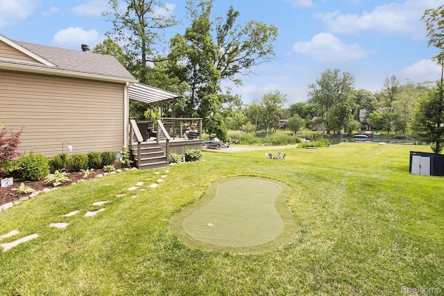 22085 Thorofare Rd, Grosse Ile, MI 48138 - view of green lawn featuring an area to practice putting and a wooden deck
