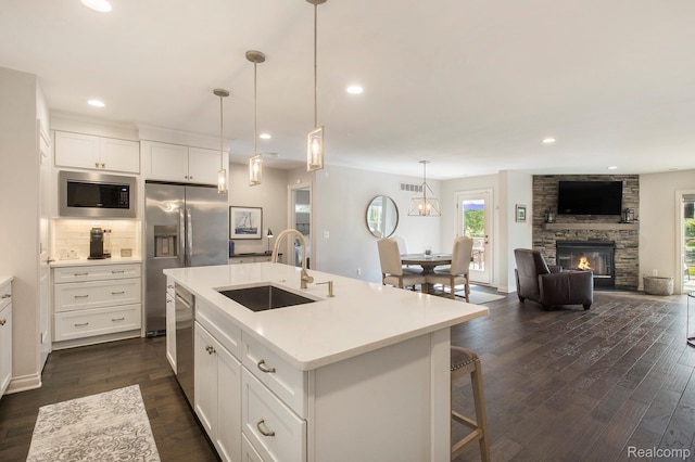 22085 Thorofare Rd, Grosse Ile, MI 48138 - kitchen with appliances with stainless steel finishes, open floor plan, dark wood-style flooring, light countertops, and recessed lighting