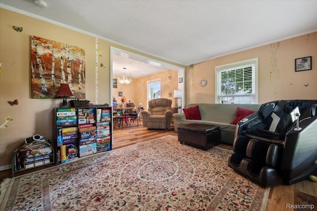 17013 Smugglers Cove St, Clinton Township, MI 48038 - living area featuring wood finished floors, a chandelier, healthy amount of natural light, and crown molding